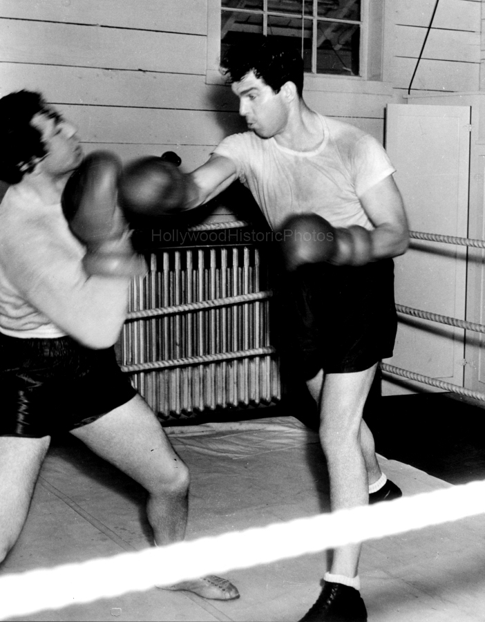 Fred MacMurray 1936 Boxing with sparing partner at the Paramount barn gym wm.jpg